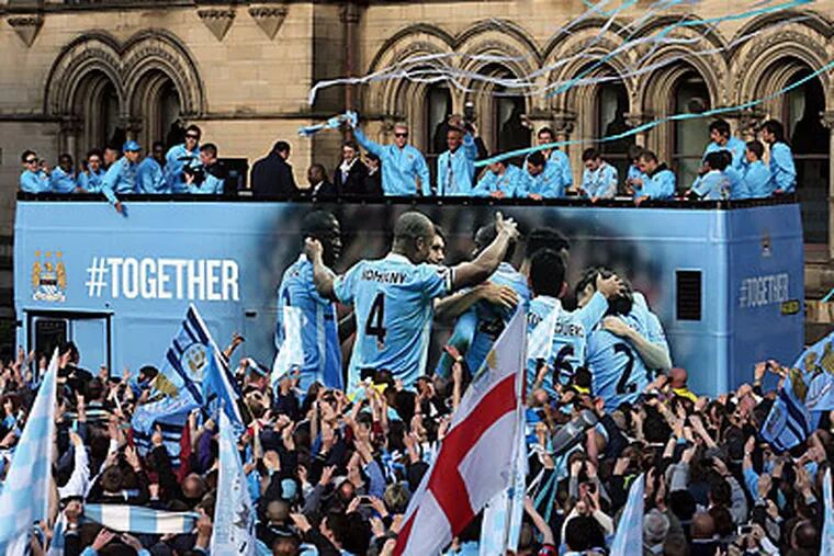 Manchester City celebrated its Premier League title with a parade on Monday. (Jon Super/AP)