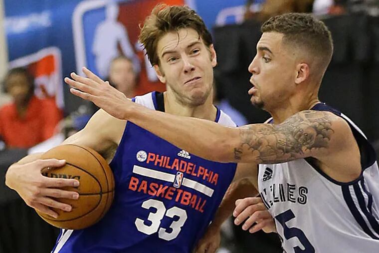 Travis Bader (33) pushes his way past Memphis Grizzlies' Scottie Wilbekin, right, on a drive to the basket during an NBA summer league basketball game in Orlando, Fla., Friday, July 11, 2014. (John Raoux/AP)