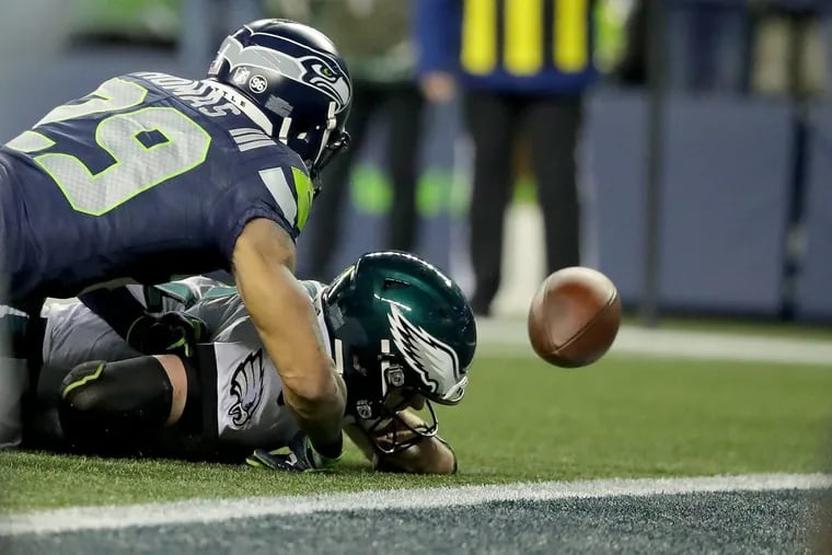 Eagles quarterback Carson Wentz (right) fumbles the ball away as the Seahawks’ safety Earl Thomas tackles him during the Eagles’ 24-10 loss to the Seahawks at CenturyLink Field.