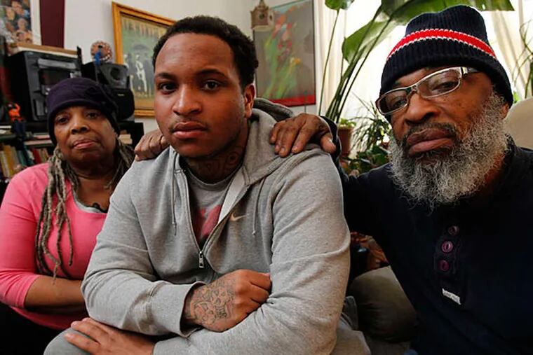 Shaquille Rainey maintains he never told Philadelphia police detectives that his cousin was the shooter in a 2009 slaying. The interrogation was not videotaped. Here, the 20-year-old is flanked at home by aunt Vernell Rainey and his father, Wayne Rainey. (Alejandro A. Alvarez/Staff)