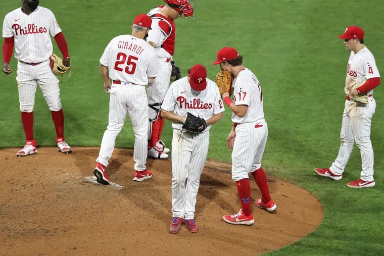 Aaron Nola gets pulled in the sixth inning after giving up a two-run home run to Miami's Jesús Aguilar Friday night in the Phillies' opener.