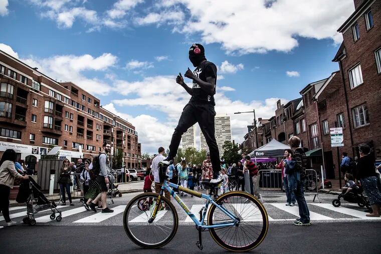 Antuan Stevenson - aka hotboyztwizzy - rides standing on his bike along South Street, Sunday, April 21, 2019.