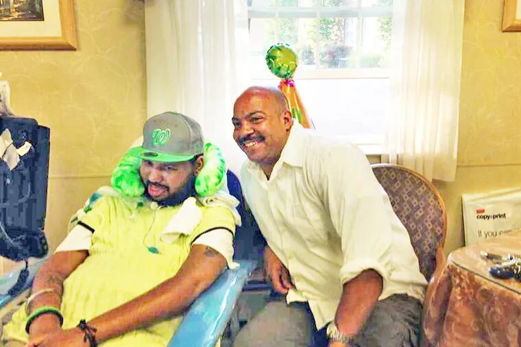 D.A. Seth Williams with his cousin Wayne "Fade" Mack, who has ALS. (Credit: Tayor Williams)