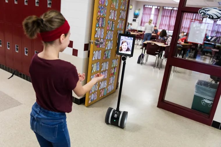 Jilly DeStephano’s robot is guided out of social studies class and into the hallway by her friend at Octorara Intermediate School in Atglen, Pa.