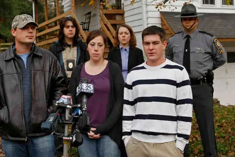 The family - (front, from left) James Milliner, Laura Peperato, and Paul Bartholomew - discusses the killing of their two dogs. Also there were (back, from left) Cheryl Shaw, of the SPCA; Cara McCree, state police corporal; and Trooper Corey Manthei.