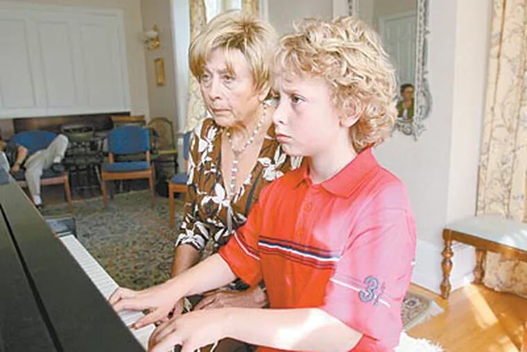 Carson Atlas, 8, works on his keyboard skills under the tutelage of piano teacher Nelly Berman. The Haverford third grader will be a finalist in the “Classical Music Idol” competition in May. (CHARLES FOX / Staff Photographer)