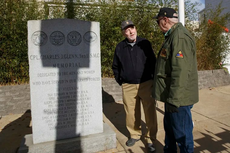 (Left to Right) John Lonergan, center, and George Ludwig, right, gather to prepare for an event that will occur on Saturday, when local residents will commemorate the 50th anniversary of their efforts to establish a community-funded memorial for Vietnam veterans, in Fishtown.