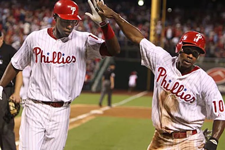 John Mayberry Jr. celebrates his home run against the Reds with Juan Pierre. (Ron Cortes/Staff Photographer)