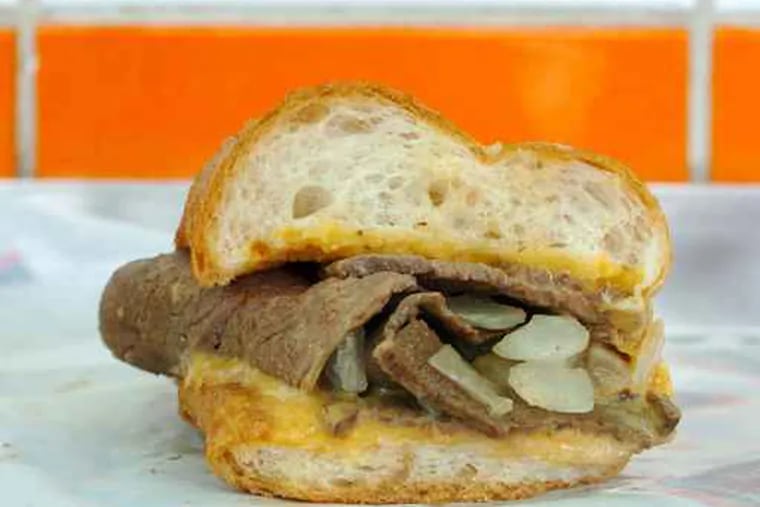 A cross-section of a Geno's steak with Cheese Whiz and onions.