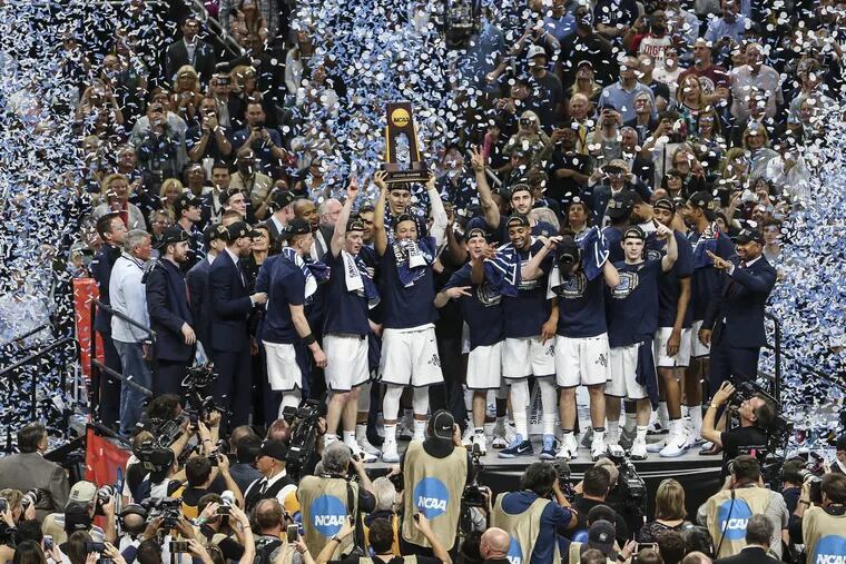 Villanova players and coach Jay Wright celebrate after winning the Wildcats’ third NCAA men’s basketball championship in school history. Villanova beat Michigan, 79-62, in the title game in San Antonio.