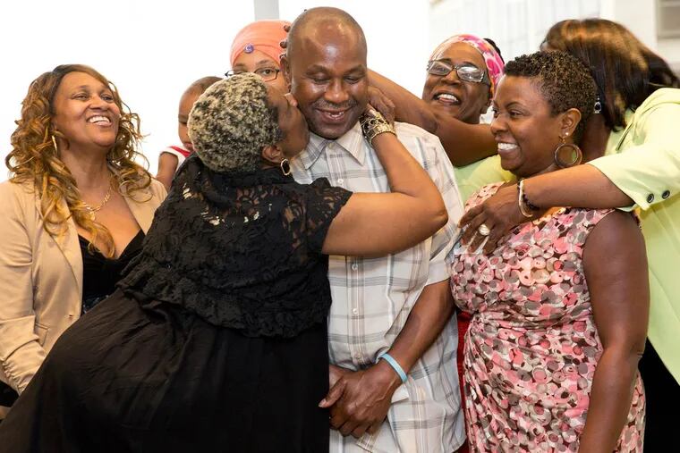Tyrone Jones is surrounded by family at Cozen O’Connor offices. He is the first Philadelphian released under a 2012 Supreme Court ruling against mandatory life sentences for juveniles.
