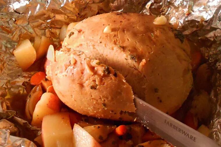 When your Tofurky is done, use a large bread knife to slice it into slices or wedges. Serve the roasted veggies on the side. The Tofurky has stuffing inside (not quite visible here).