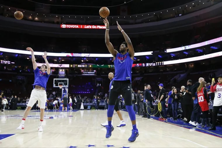 Center Joel Embiid and forward Ersan Ilyasova take shots during warm-ups ahead of Game 2 of the Sixers’ first round series against the Miami Heat Monday.