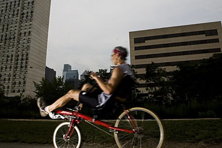 A bicyclist rides along the Schuylkill.  Studies show people are cutting back on driving.
