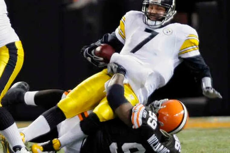 Steelers QB Ben Roethlisberger is sacked in the first quarter. Last night's game ended too late for this edition.