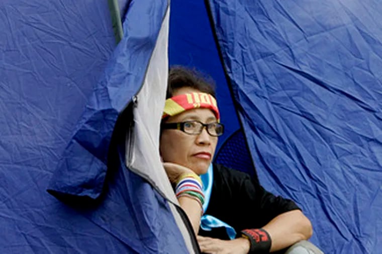 A protester in Bangkok looks out from her tent at Government House, the seat of the Thai government. The People&#0039;s Alliance for Democracy has been in a months-long standoff withthe government, which the alliance has vowed to topple.