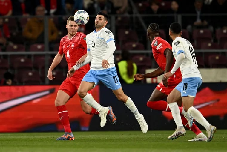 Israel forward Tai Baribo (center) fights for the ball with Switzerland's Nico Elvedi (left) during a UEFA Euro 2024 qualification match on March 28.