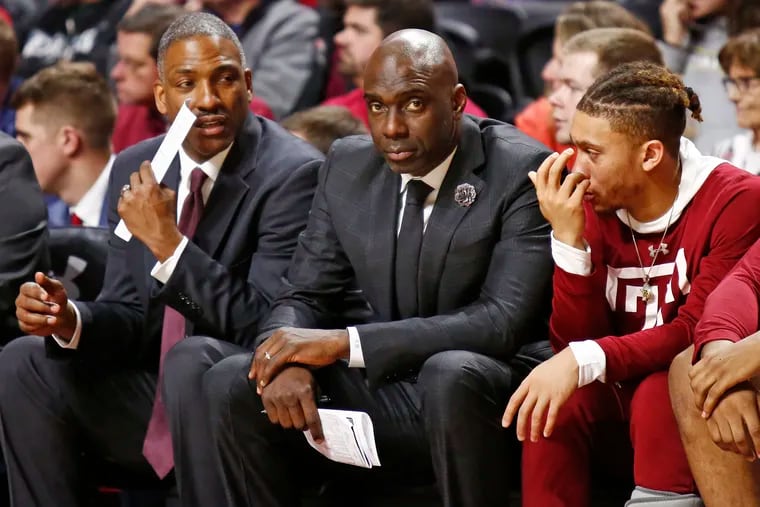 Aaron McKie (center) on the sideline during a January Temple game.