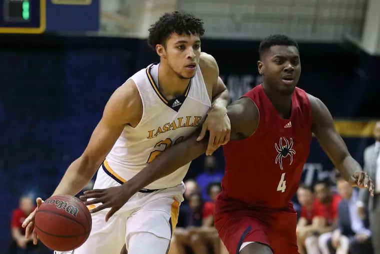 La Salle forward Clifton Moore dribbles the basketball defended by Richmond forward Nathan Cayo during the second half on Saturday, January 22, 2022.