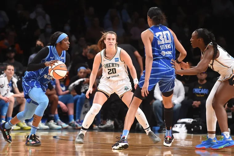 Kahleah Copper (left) looks to pass in front of Sabrina Ionescu (center) and Azurá Stevens (right) during the second half of Sunday's Chicago Sky-New York Liberty game in Brooklyn.