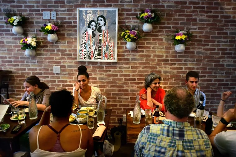 The dining room at Kalaya, 764 S Ninth St. The print on the wall is by Philadelphia artist Jeremy Hush.