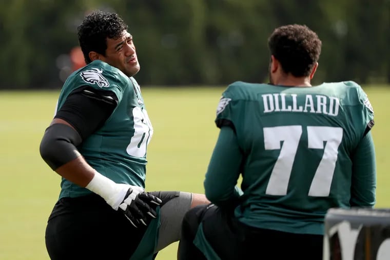 Eagles offensive tackles Jordan Mailata (left) and Andre Dillard talk during training camp in August.