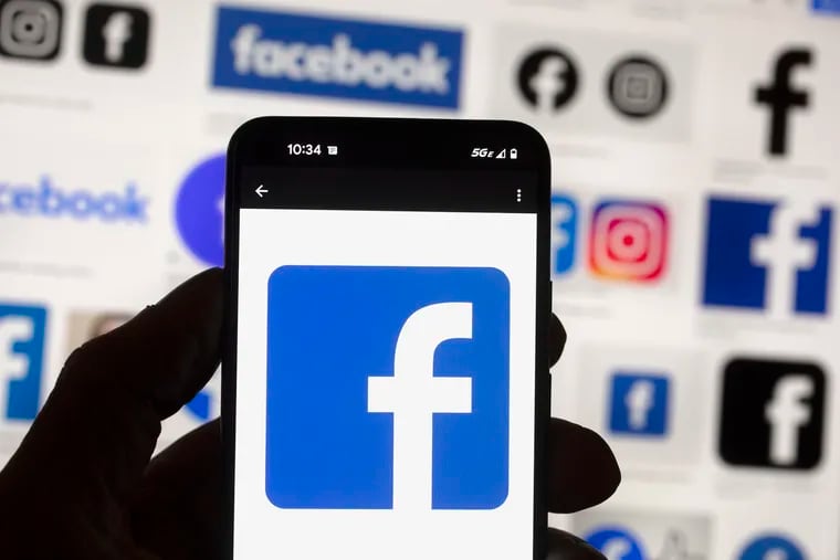 The Facebook logo is seen on a cell phone in Boston, USA, Oct. 14, 2022. (AP Photo/Michael Dwyer, File)