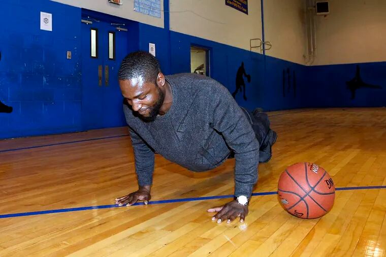 Tyrique Glasgow does a push-up after missing a shot during a basketball shootaround at the Ford PAL Center in South Philadelphia on April 2, 2015. (YONG KIM/Staff Photographer)