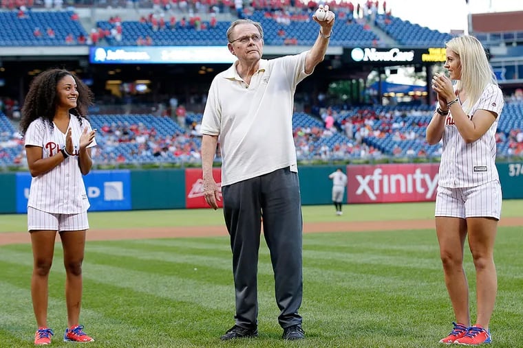Retired Inquirer columnist Bill Lyon prepares to deliver the first pitch with Phillies ballgirls Temaya (left) and Samantha on Alzheimer's Awareness Night.