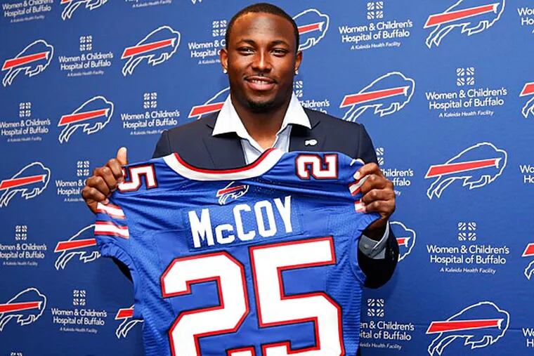 Buffalo Bills running back LeSean McCoy holds up his new jersey after a press conference at Ralph Wilson Stadium. (Kevin Hoffman/USA Today)