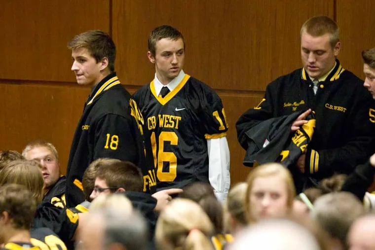 Members of the Central Bucks West football team arrive for the meeting. The Central Bucks School Board explained its decision to cancel the rest of the football season and suspend the coaching staff. ( CHARLES FOX / Staff Photographer )