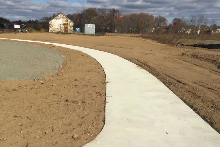 A concrete path marks the first stage of construction at Moorestown&#039;s new dog park. The three-acre park, with two fenced dog runs, parking and a pavilion, will cost $353,619 and open next year.