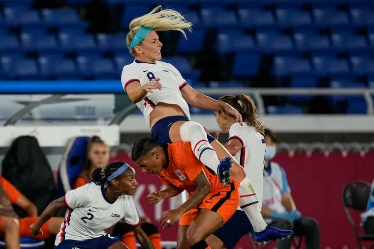 Julie Ertz (8) of the United States falls over Shanice van de Sanden (7) of the Netherlands in the first half. MUST CREDIT: Washington Post photo by Toni L. Sandys