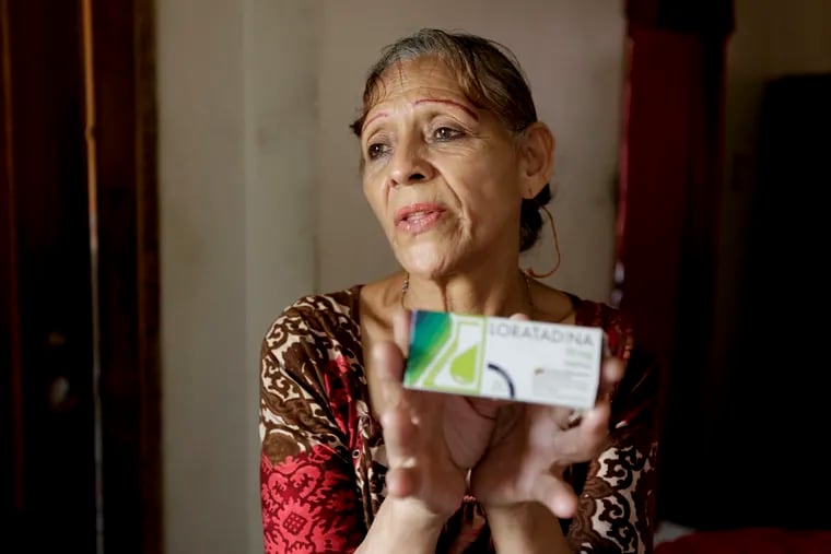 In this April 11, 2019 photo, Bertha Dun shows medicine bought with cryptocurrency through online transfers, in Barquisimeto, Venezuela, Thursday, April 11, 2019. Venezuela's political and economic crisis has now made it a prime testing ground using cryptocurrency to finance social projects or send relief directly to people living in poverty.