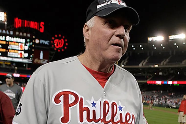 Charlie Manuel celebrated on the field after the Phillies clinched their fourth straight NL East championship. (Yong Kim/Staff Photographer)