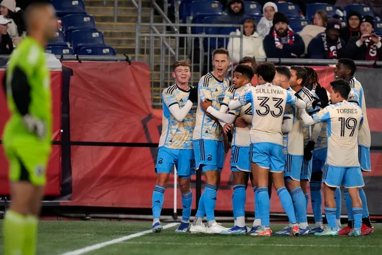 Joaquín Torres (19) and the rest of the Union gather around Chris Donovan to celebrate his game-winning and series-clinching goal at New England.