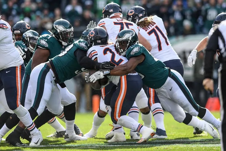 Eagles defensive linemen Tim Jernigan (left) and Brandon Graham (right) stop Chicago running back Jordan Howard for a 1-yard loss in the first quarter of the Eagles' 31-3 win over the Bears.