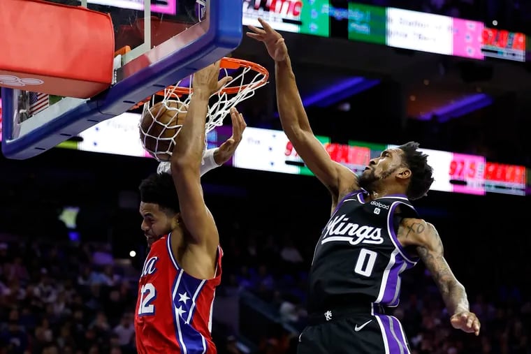 Sixers forward Tobias Harris dunks the basketball past Sacramento Kings guard Malik Monk in the second quarter on Friday, January 12, 2024 in Philadelphia.