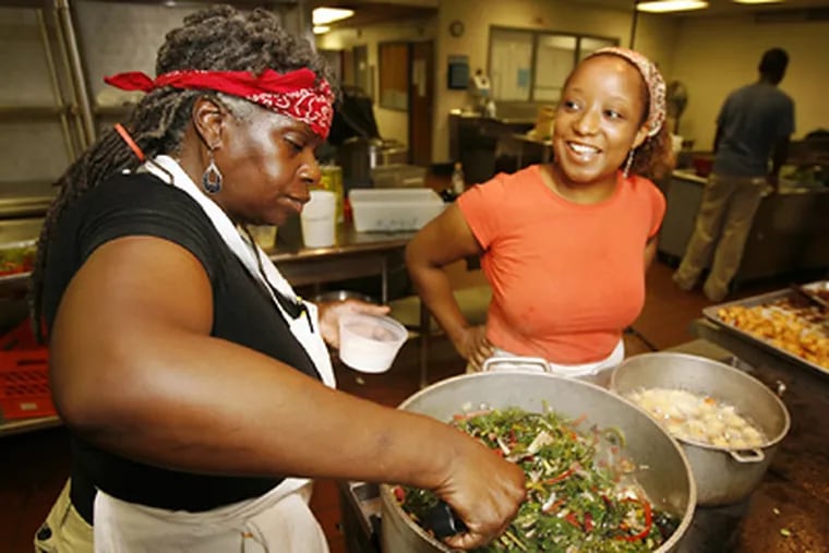 Valerie Erwin (left) and Hilary Johnson, of the Geechi Girl Rice Cafe in Mount Airy, helped in serving. (Alejandro A. Alvarez / Staff Photographer)