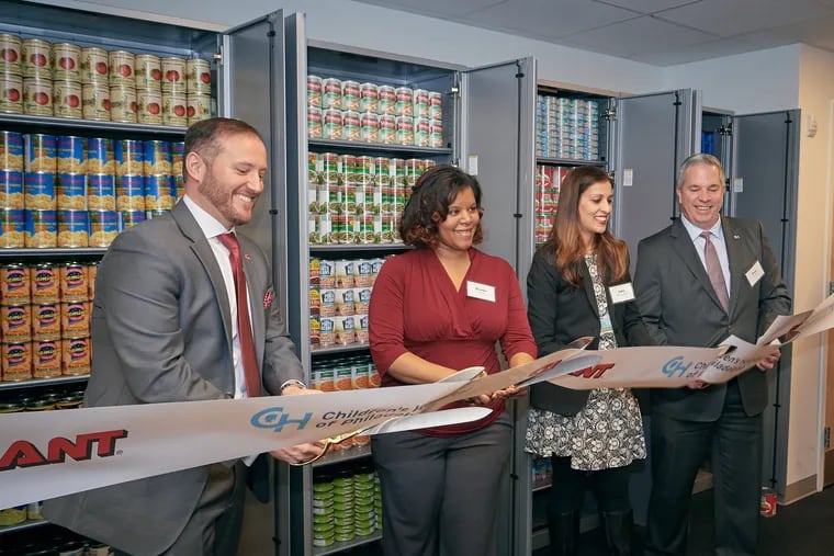 Nicholas Bertram (from left), president of Giant Food Stores; event speaker Brooke Belle; Dr. Saba Khan; and Doug Hock, executive vice president and chief operating officer at CHOP, cut the ribbon for CHOP's new Healthy Weight Food Pharmacy, which Khan will direct.