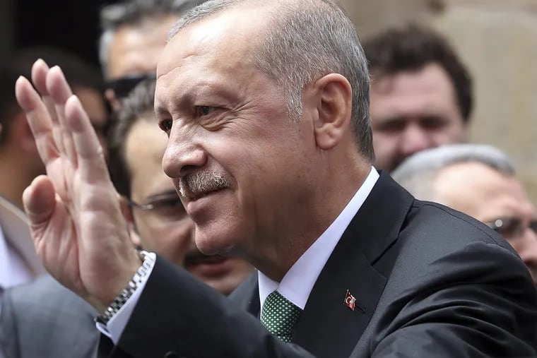 Turkey's President Recep Tayyip Erdogan listens to supporters after Friday prayers, in Bayburt, Turkey, Friday, Aug. 10, 2018.