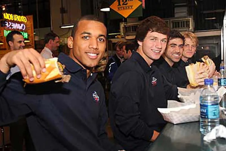 Teal Bunbuby (left), Jack McInerney, Austin da Luz and Brian Perk eat Carmen's cheesesteaks. (Sharon Gekoski-Kimmel/Staff Photographer)