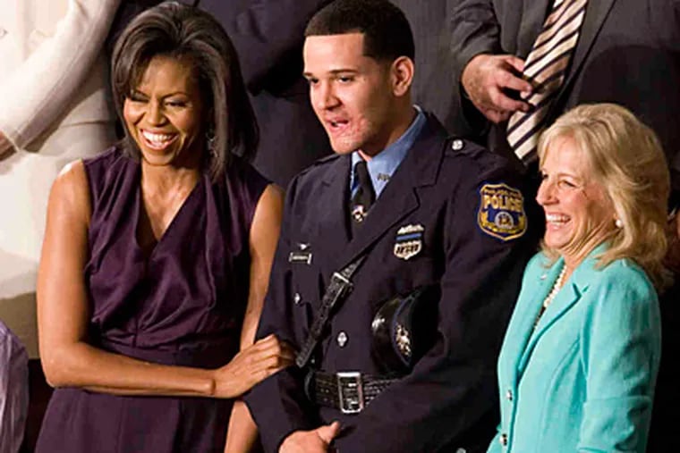 Richard DeCoatsworth in happier times, as he joined first lady Michelle Obama and Jill Biden at a presidential address in 2009. (Associated Press/File)