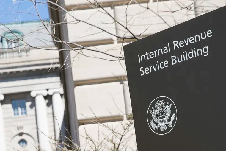 FILE photo shows a logo sign outside of the IRS headquarters. The federal agency isn’t doing enough to audit corporate mergers and acquisitions and is wasting tens of thousands of days on cases that aren’t likely to generate more tax dollars, the agency’s watchdog said.