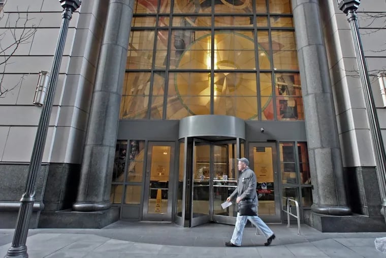 In a file photo, a man walks past the Stout Criminal Justice Center in Philadelphia.