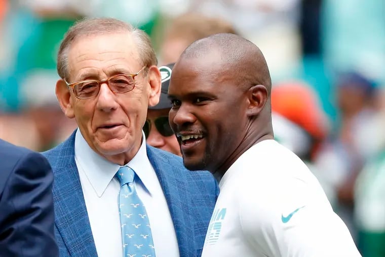 Former Dolphins head coach Brian Flores talks to Miami owner Stephen Ross in 2019, soon after Ross allegedly ordered Flores to lose games on purpose.