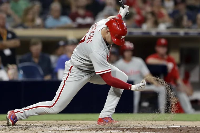 Rhys Hoskins throws a handful of dirt after striking out during Friday's loss to the Padres.