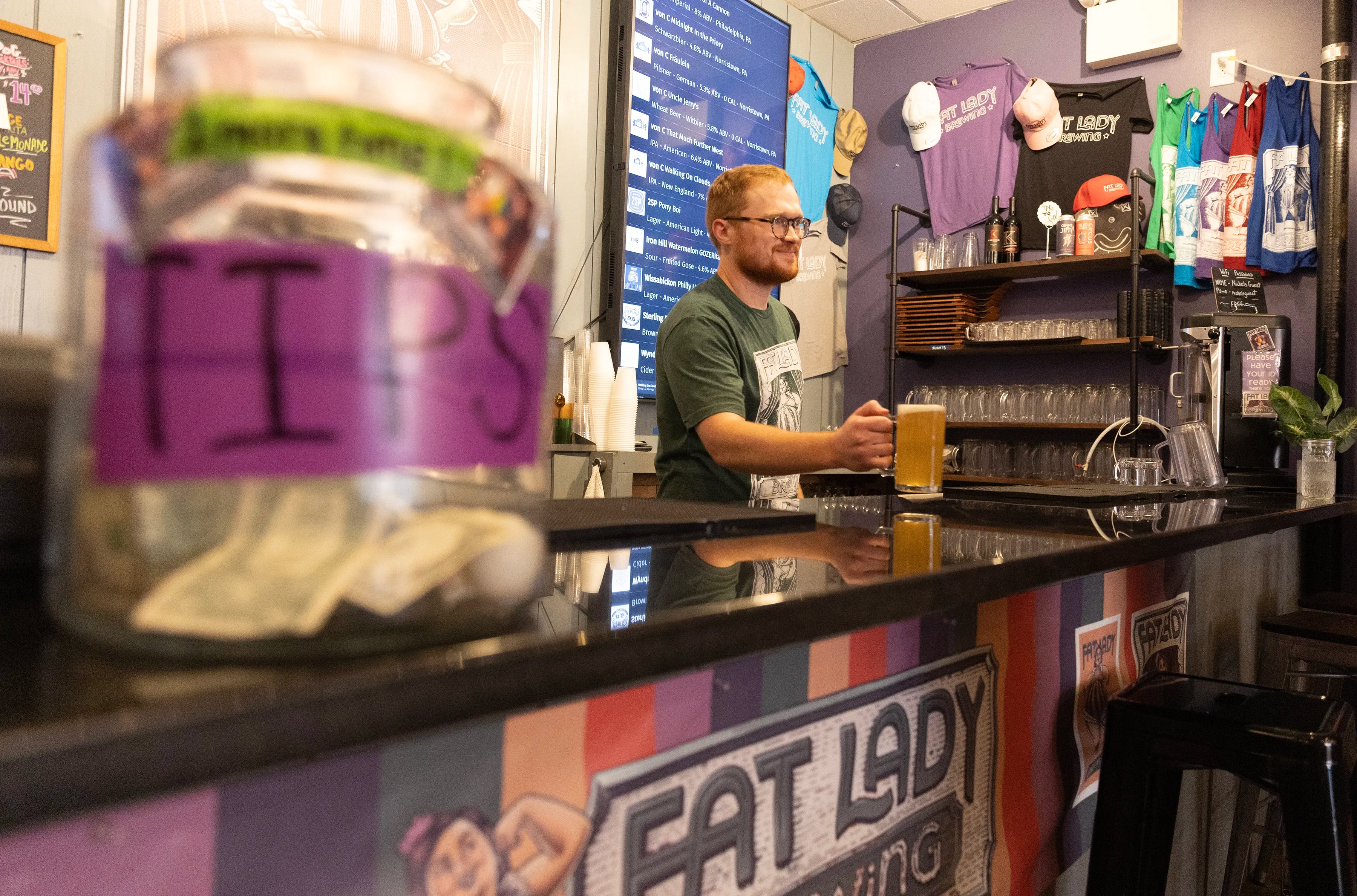 Bartender Evan DiGregory serves a beer at Fat Lady Brewing Company in Manayunk.
