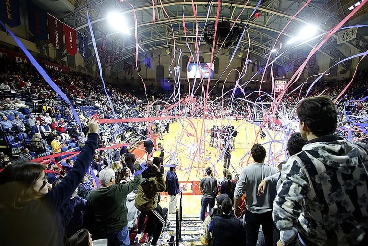 Penn students throw streamers on the court before Penn played Saint Joseph’s at the Palestra in January of 2016.