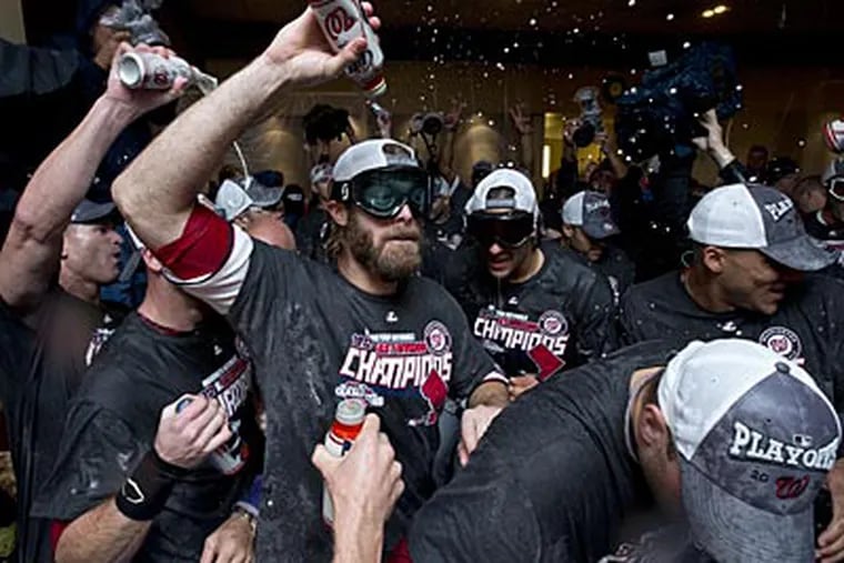 Jayson Werth, a former Phillie, celebrates with his Nationals teammates after clinching the NL East title. (Manuel Balce Ceneta/AP)